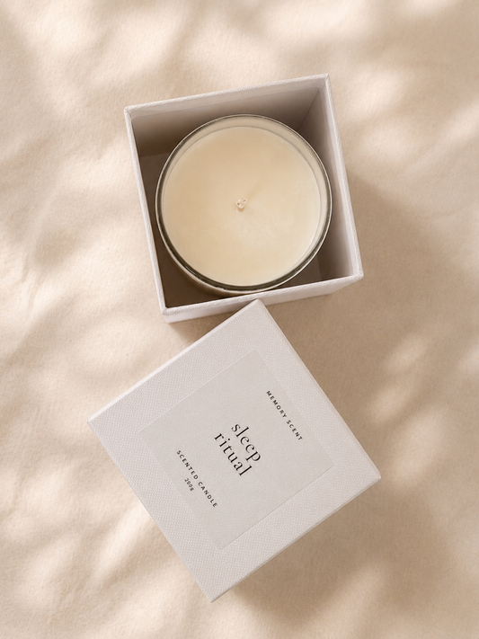 Candle in a white box labeled 'sleep ritual' on a beige background