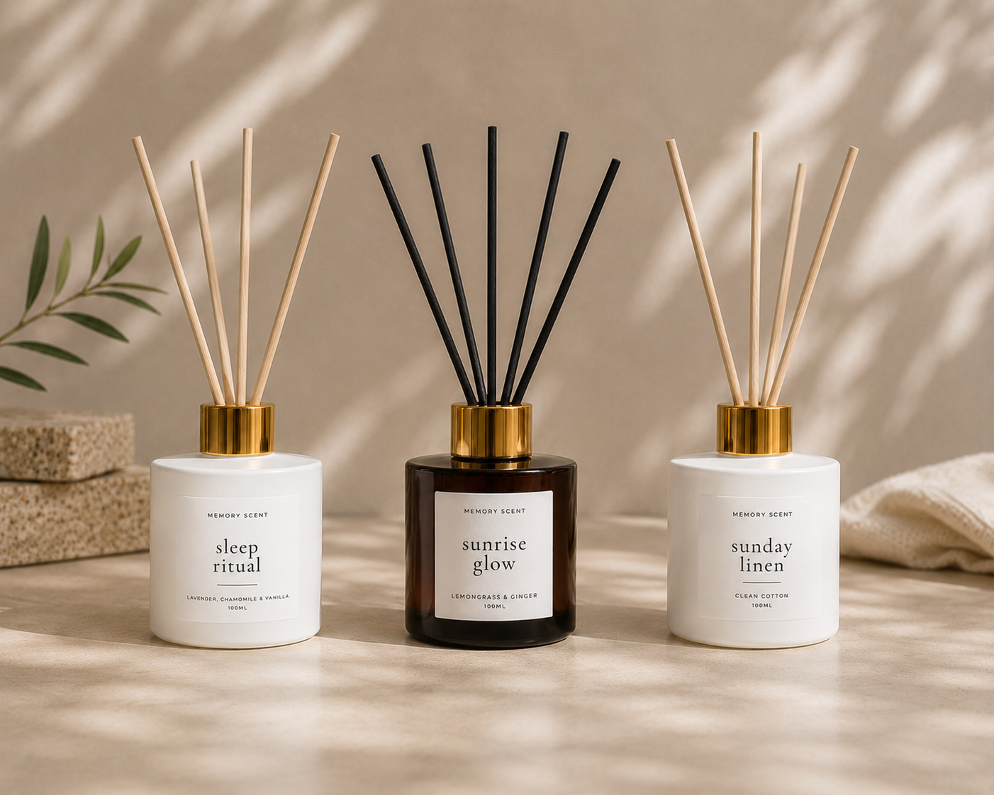 Three reed diffusers in a row on a beige background.