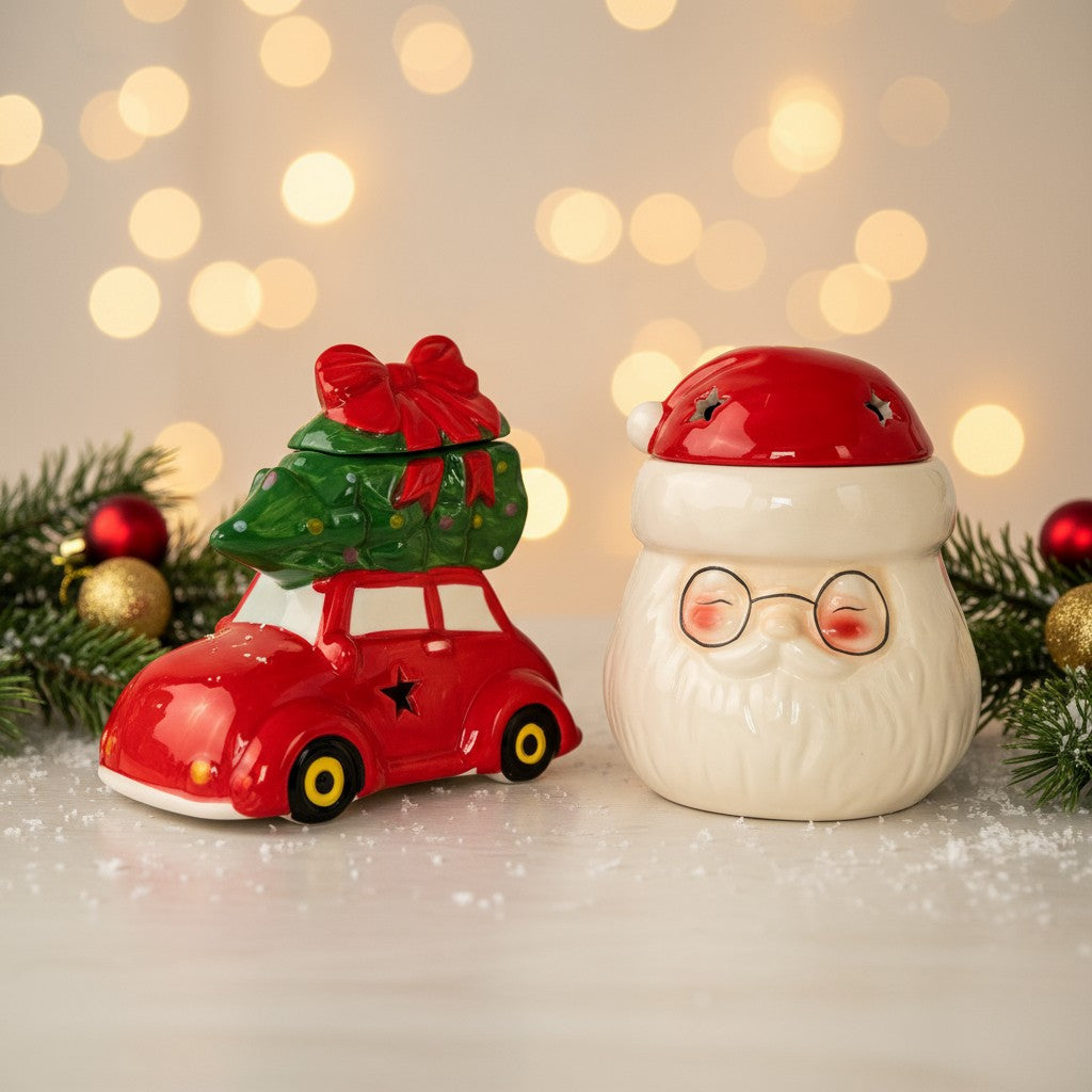 Christmas Wax Burners on a festive themed table with lights in the background and christmas decor surrounding them.