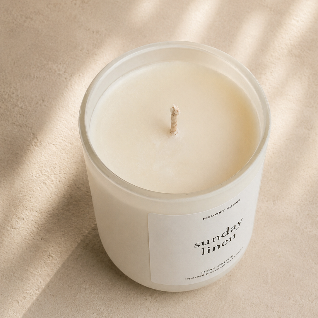 Candle in a glass jar with a label on a beige background