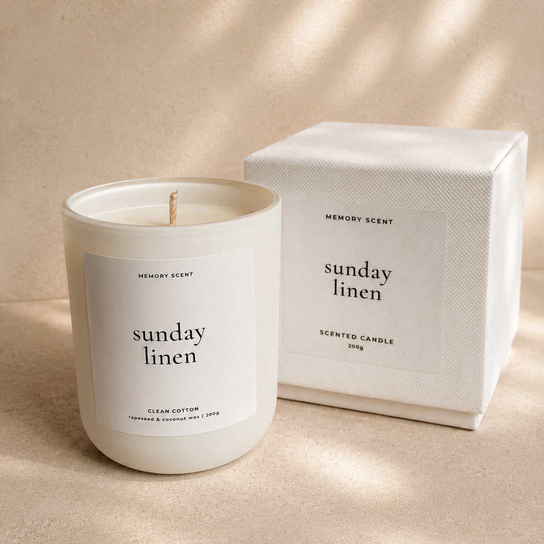 Scented candle labeled 'Sunday Linen' with a matching box on a beige background