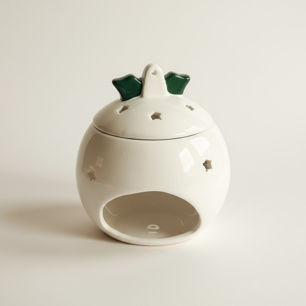 Christmas Pudding Wax Burner facing the back, showing the back where the tealight goes, on a plain white background. 