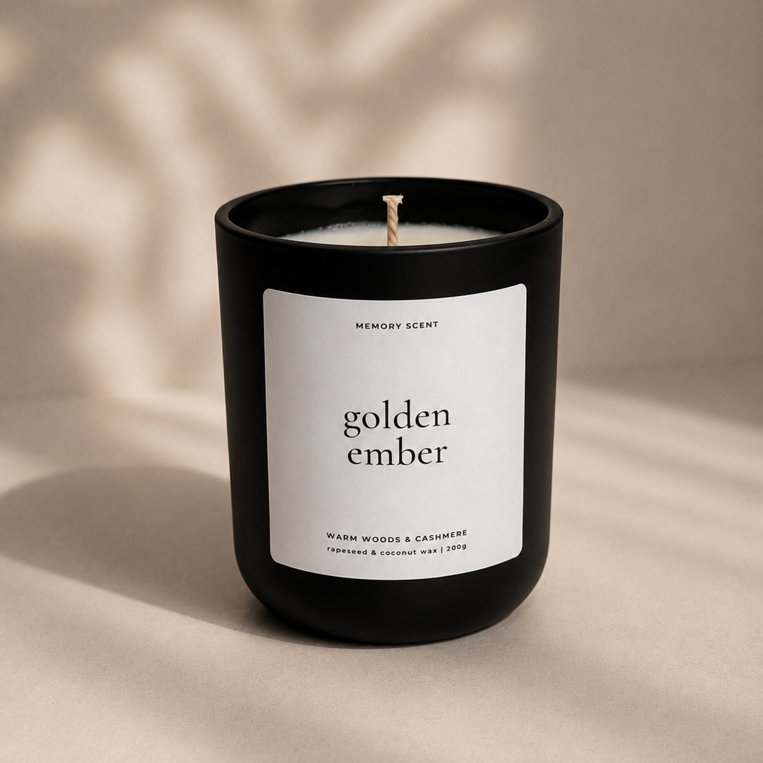 Candle labeled 'golden ember' on a beige background