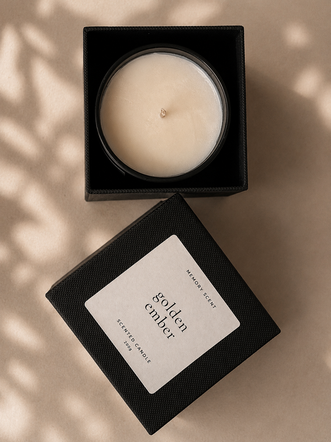 Candle in a black box labeled 'golden ember' on a beige background