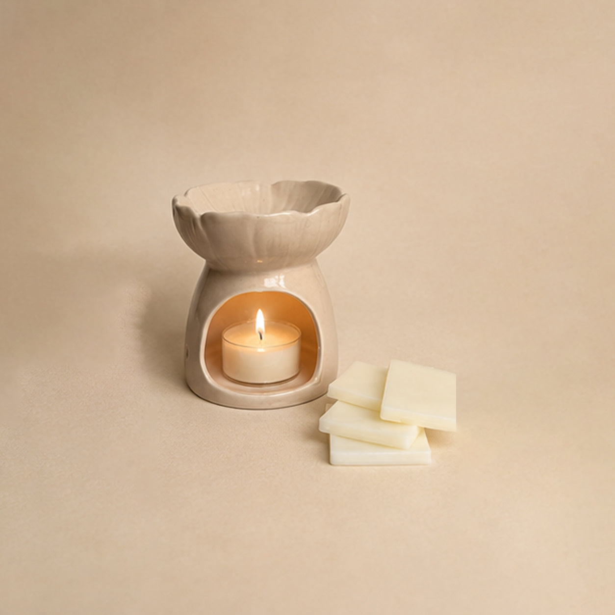 Back view of the pink blossom ceramic wax burner with tealight lit and snap bar blocks on the side.