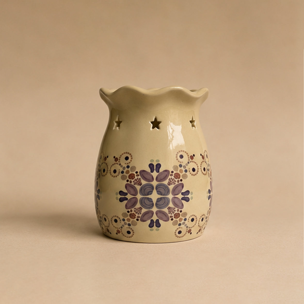Decorative ceramic wax burner with sea themed pattern on a beige background