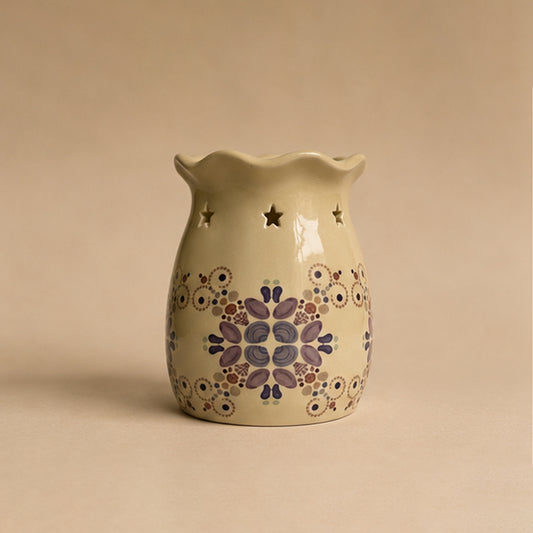Decorative ceramic wax burner with sea themed pattern on a beige background