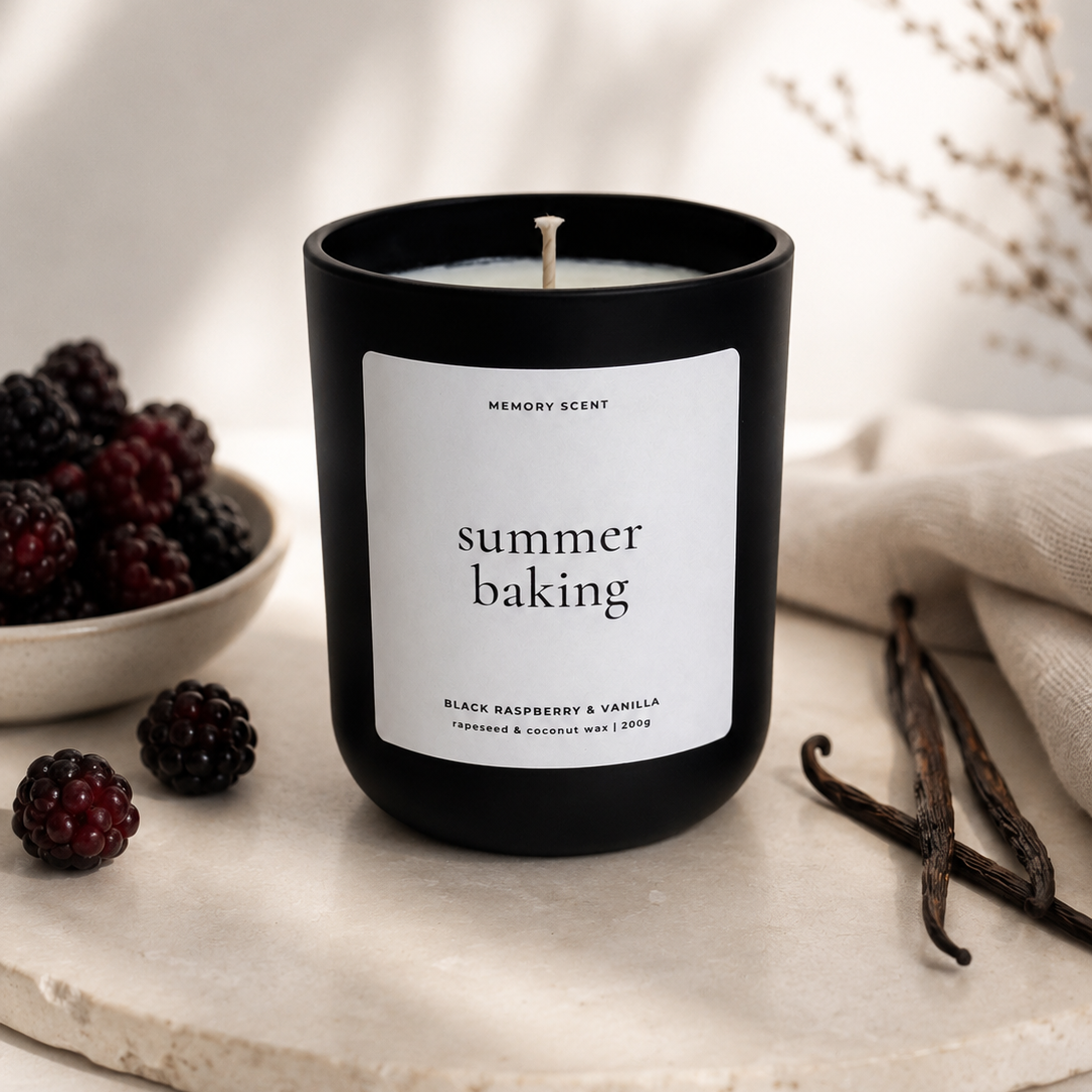 Candle labeled 'summer baking' with blackberries and vanilla beans on a neutral background