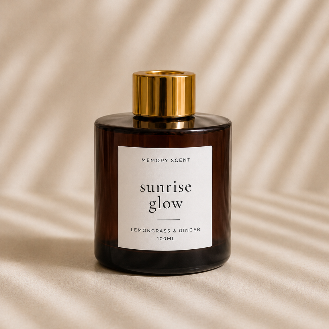 Amber diffuser jar with a gold cap on a beige background. 