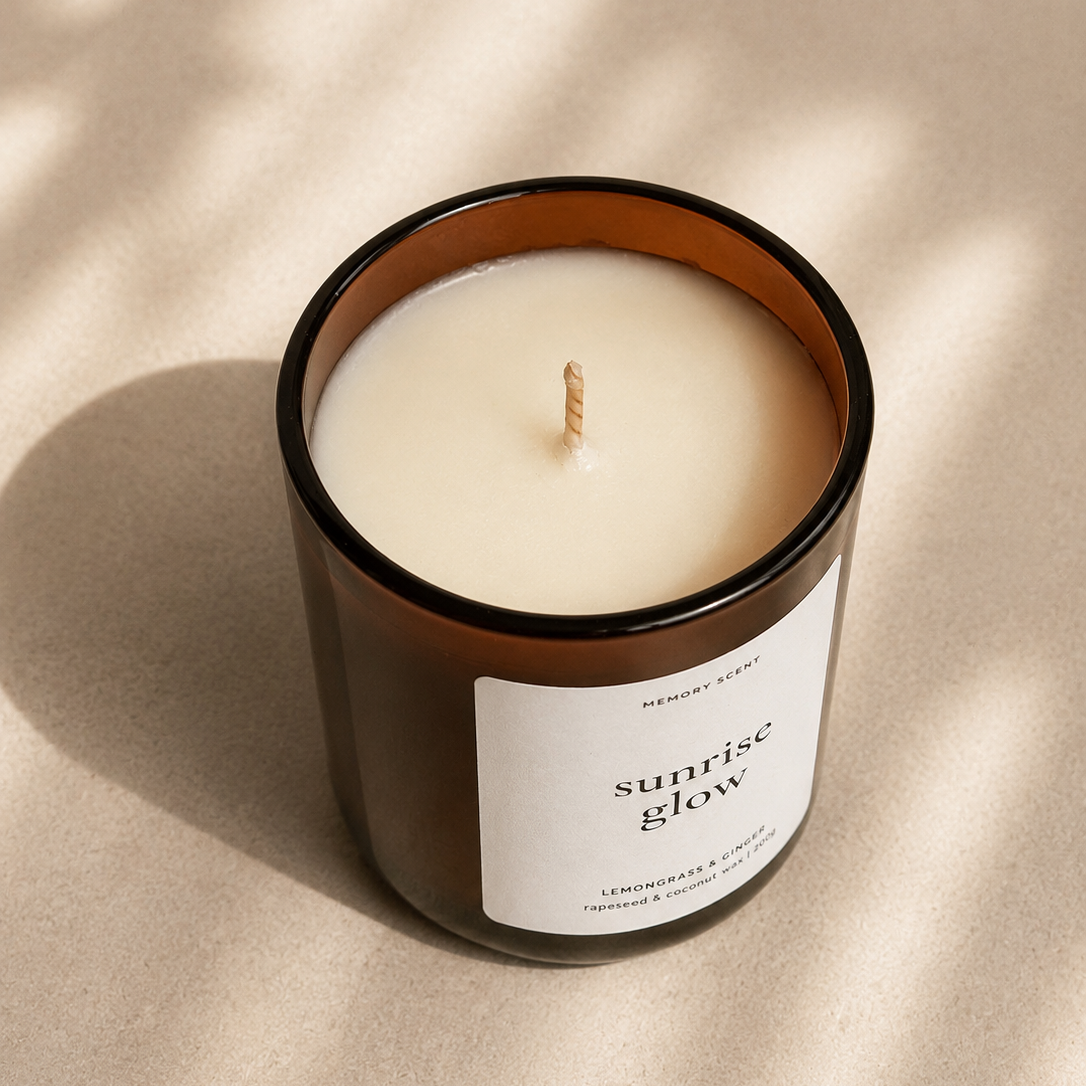 Candle labeled 'sunrise glow' on a beige background