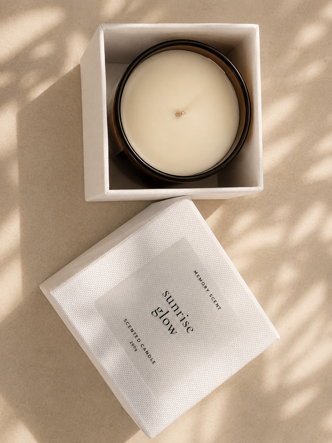 Scented candle in a white box on a beige surface with soft shadows